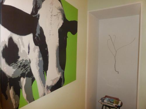 a painting of cows on the wall of a room at iBed Napoli B&B in Naples
