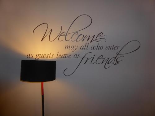 a welcome may all who enter as guests leave as friends wall art sticker at iBed Napoli B&B in Naples