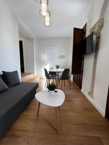 a living room with a couch and a table at Apartamentos Rey in Córdoba
