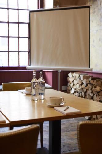 a table with two bottles of water on it at The Archangel,Restaurant & Bar with Rooms in Frome