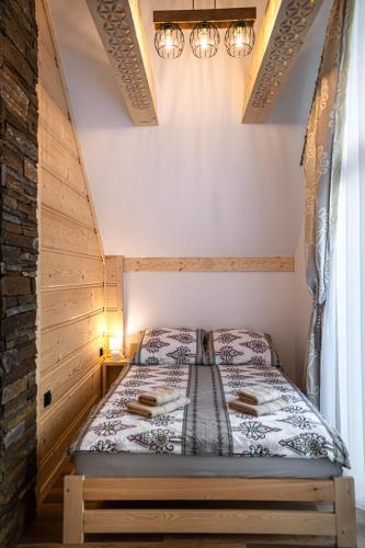 a bedroom with a bed in a room at Modrzewiowa Ostoja in Kluszkowce