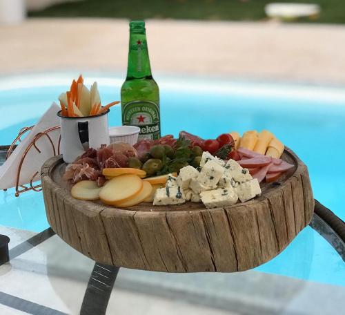 a plate of food and a bottle of beer at Pousada Vila Santa Maria in Pirenópolis