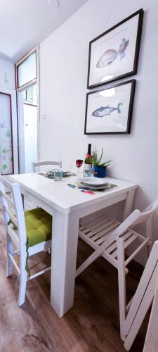 a white dining room table with chairs and a white table at Apartment Gallery Zagreb in Zagreb