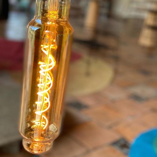 a glass bottle with a yellow liquid in it at Hotel Casa Paradiso Guarujá in Guarujá