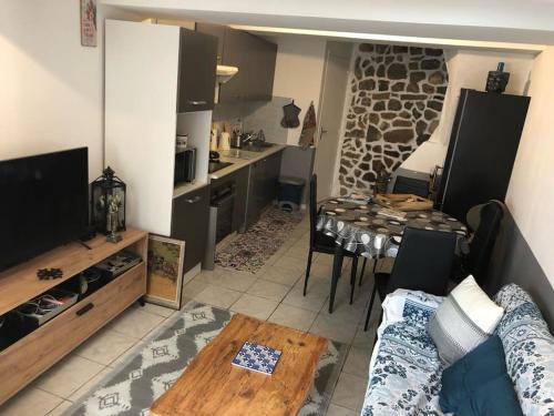 Il dispose d'une cuisine et d'un salon avec une table et un canapé. dans l'établissement Coquette maison de village dans village typique,, à Lapalme