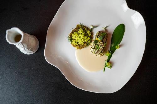 a white plate with some food on a table at Romantik Hotel & Restaurant Stafler in Vipiteno