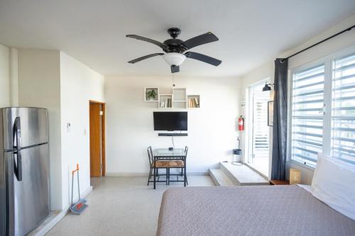 a bedroom with a bed and a ceiling fan at La Esmeralda PR in San Juan