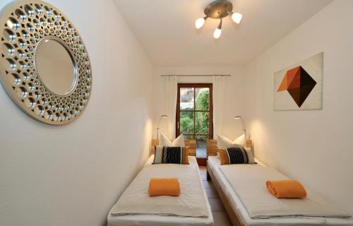 Zimmer mit 2 Betten und einem Wandspiegel in der Unterkunft Fritz-Müller in Garmisch-Partenkirchen