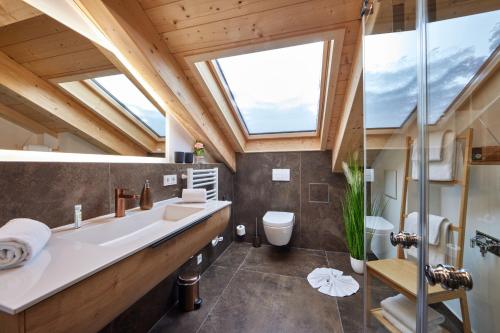 a bathroom with a large sink and a large window at Chalet Wild in Garmisch-Partenkirchen