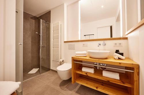 a bathroom with a sink and a toilet and a shower at Hirsch in Garmisch-Partenkirchen