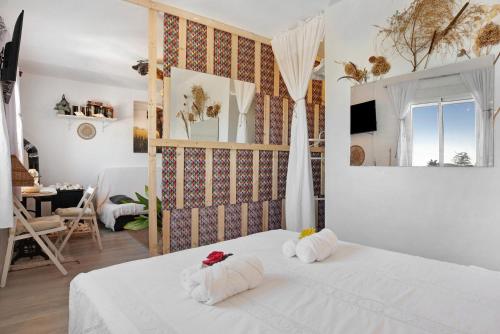 1 dormitorio con 2 toallas blancas en una cama en Casa Chipiron, en Vejer de la Frontera