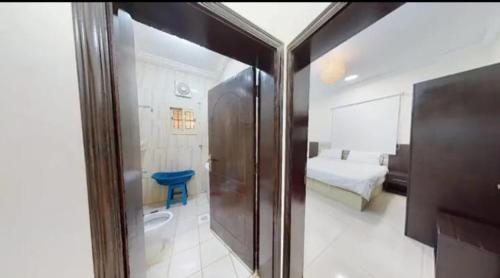 a view of a room with a bed and a bathroom at Sharm Beach Suites Private hotel apartments in Yanbu