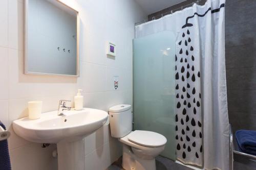 a bathroom with a toilet and a sink and a shower at RentOnTheBeach Studio 2 in Los Cristianos