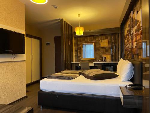 a bedroom with a large bed and a television at Lider HOTEL in Istanbul