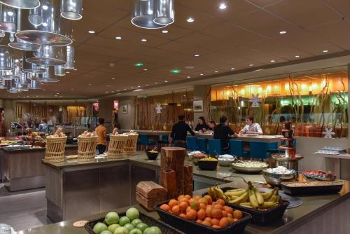 a buffet line with fruits and vegetables in a restaurant at Villages Clubs du Soleil - LES 2 ALPES in Les Deux Alpes