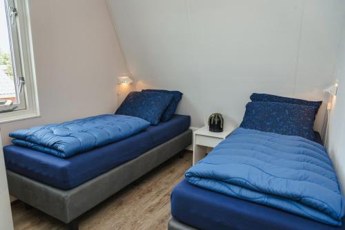 een bed en een futon in een kamer bij Veluwe Strandbad Elburg in Elburg
