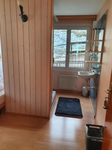 a bathroom with a shower and a sink and a mirror at Hotel - Restaurant Rhoneblick in Guttet-Feschel