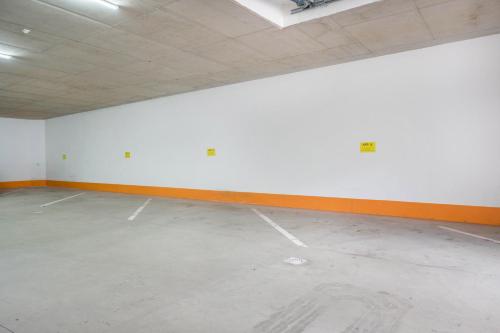 an empty room with a white wall and orange trim at Haus zur Vogelweide App 5 in Dobbiaco