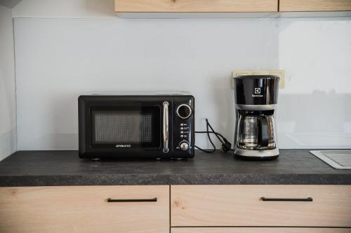 a microwave sitting on top of a kitchen counter at Mojčin Pisker Apartment House in Kranj