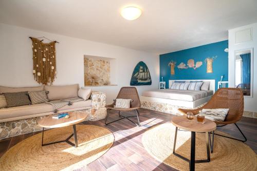 a living room with a couch and a bed at Libera Apartments in Stara Baška