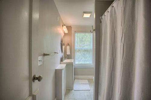 a bathroom with a shower and a sink and a window at Suites on Seneca - Beautiful 1 Bedroom Apartment in Harrisburg