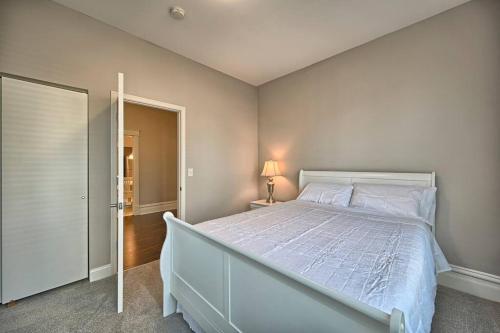 a bedroom with a large white bed and a doorway at Suites on Seneca - Lovely 2 Bed 1 Bath Apartment in Harrisburg
