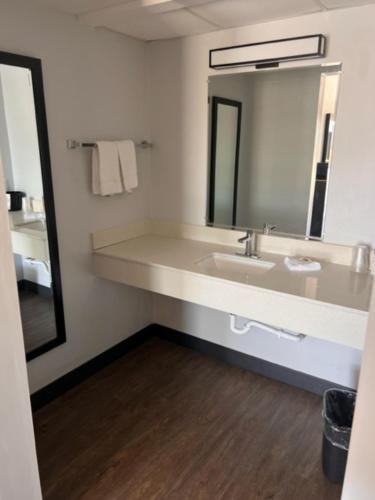 a bathroom with a sink and a mirror at Motel 6 Dublin, Ga in Dublin