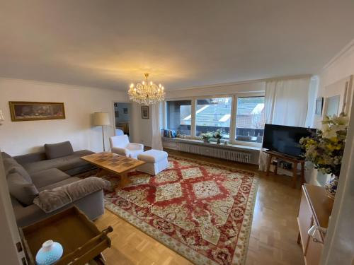 a living room with a couch and a table at Ferienwohnung Sonnenaufgang Bad Tölz in Bad Tölz