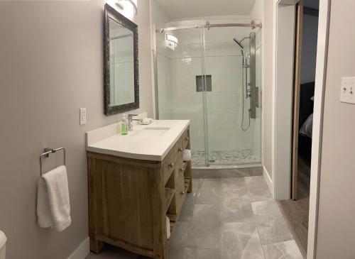 a bathroom with a sink and a shower at Bumblebee Bight Inn in Pilleyʼs Island