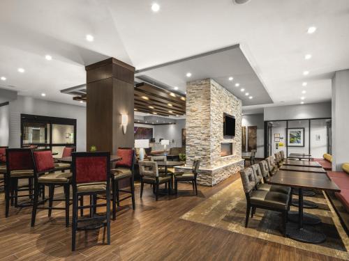 a restaurant with tables and chairs and a fireplace at Staybridge Suites Seattle - South Lake Union by IHG in Seattle