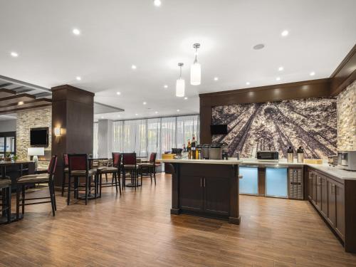 a lobby with a bar and tables and chairs at Staybridge Suites Seattle - South Lake Union by IHG in Seattle