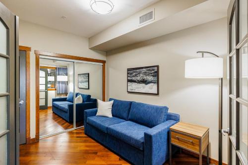 a living room with two blue couches and a table at Stoneridge Mountain Resort in Canmore