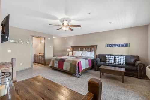 a bedroom with a bed and a couch at Table Rock Resorts at Indian Point in Branson