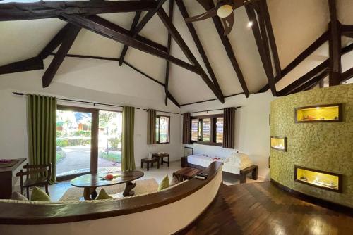 a living room with a couch and a table at Ravintsara Wellness Hotel in Ambaro