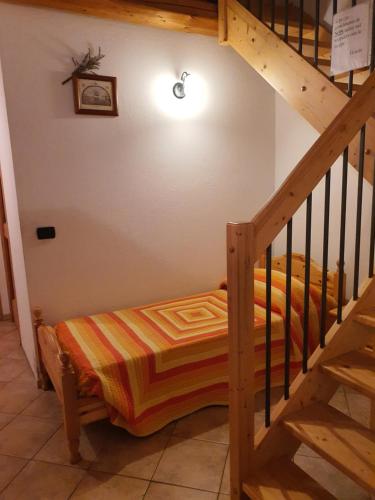 a bedroom with a bunk bed and a staircase at Agriturismo al pra di muriet in Susa