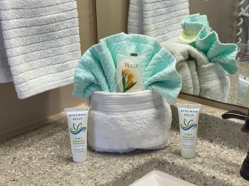a bathroom counter with two bottles of virgin hair products and a mirror at Ocean View Renovated Condo With Pool - DAYTONA BEACH in Daytona Beach