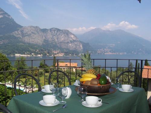 a table with a bowl of fruit on top of a balcony at Il Poggio Di Bellagio in Bellagio