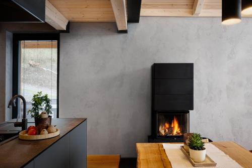 a living room with a fireplace and a table at TRI VODY Demänovská Dolina in Liptovský Mikuláš