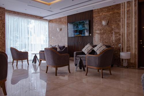 a lobby with chairs and a table and a couch at idles By Staytion Serviced Apartments in Jeddah