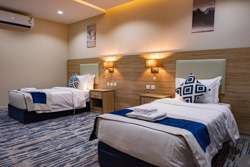 a hotel room with two beds in a room at idles By Staytion Serviced Apartments in Jeddah