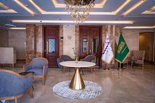 a meeting room with a table and chairs and a flag at idles By Staytion Serviced Apartments in Jeddah
