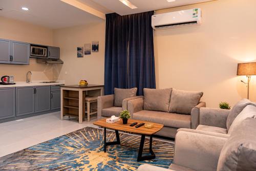 a living room with a couch and a table at idles By Staytion Serviced Apartments in Jeddah