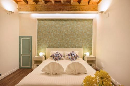 a bedroom with a large bed with two pillows at La Sinagoga Suite-Hosted by Sweetstay in Florence