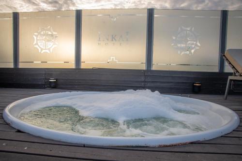 a bath tub filled with snow in front of a building at Hotel Inkai in Salta