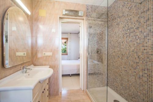 a bathroom with a shower and a sink and a tub at Villa Erik - PlusHolidays in Calpe