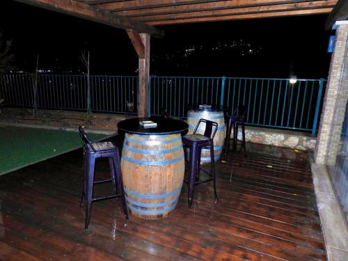 two barrel tables and chairs on a deck at night at snowflake.golan in Majdal Shams