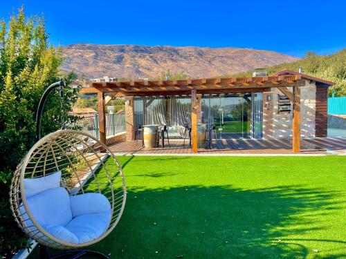 a swinging chair in a yard with a pergola at snowflake.golan in Majdal Shams