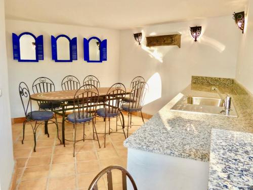 a kitchen with a table and chairs and a sink at Casa Alba in Nerja