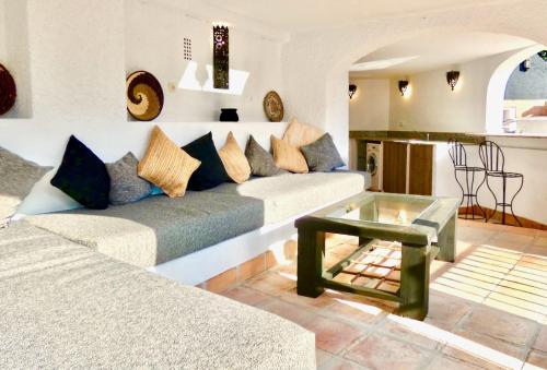 a living room with a couch and a glass table at Casa Alba in Nerja