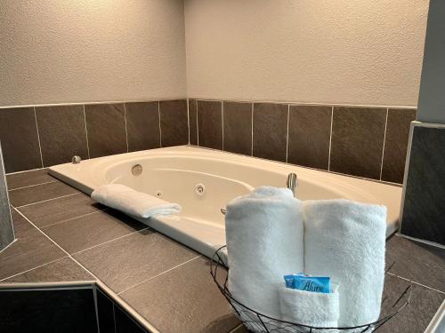 a bathroom with a tub with towels in it at Lake Norfork Resort in Henderson